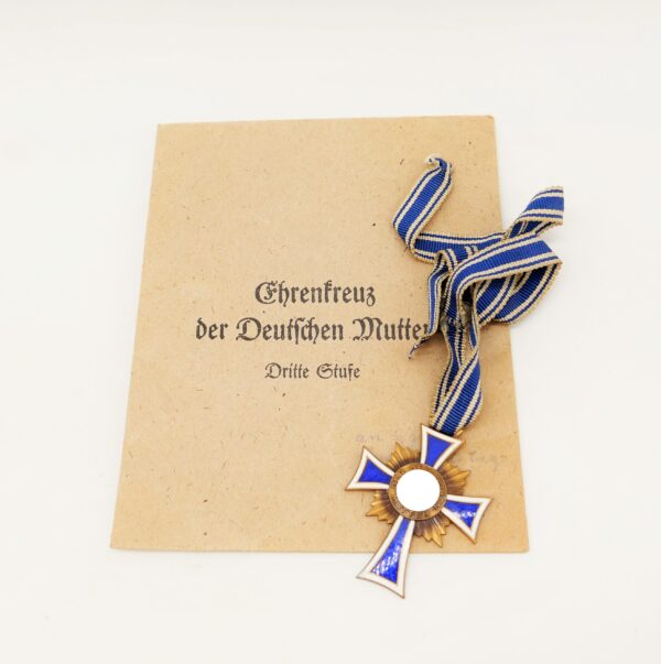 Mutterkreuz Bronze (3. Stufe) am Band - Mit der Verleihungstüte Frank & Reif, Stuttgart